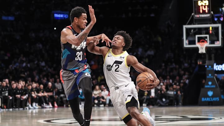Jan 29, 2024; Brooklyn, New York, USA;  Utah Jazz guard Collin Sexton (2) looks to drive past Brooklyn Nets center Nic Claxton (33) in the first quarter at Barclays Center. Mandatory Credit: Wendell Cruz-Imagn Images