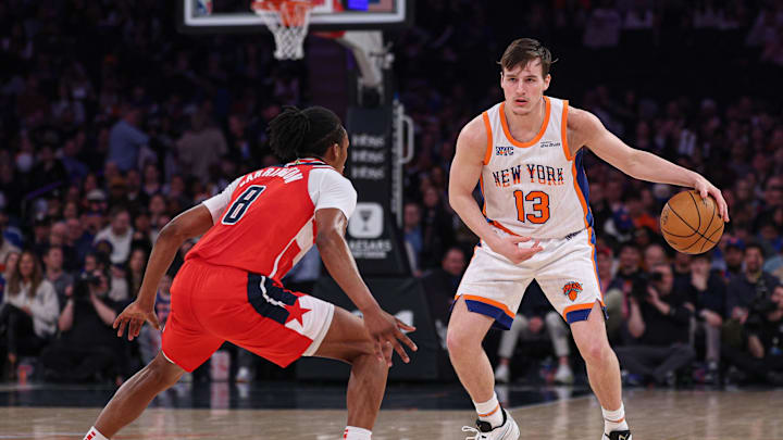 Mar 22, 2025; New York, New York, USA; New York Knicks guard Tyler Kolek (13) dribbles as Washington Wizards guard Bub Carrington (8) defends during the first half at Madison Square Garden. Mandatory Credit: Vincent Carchietta-Imagn Images