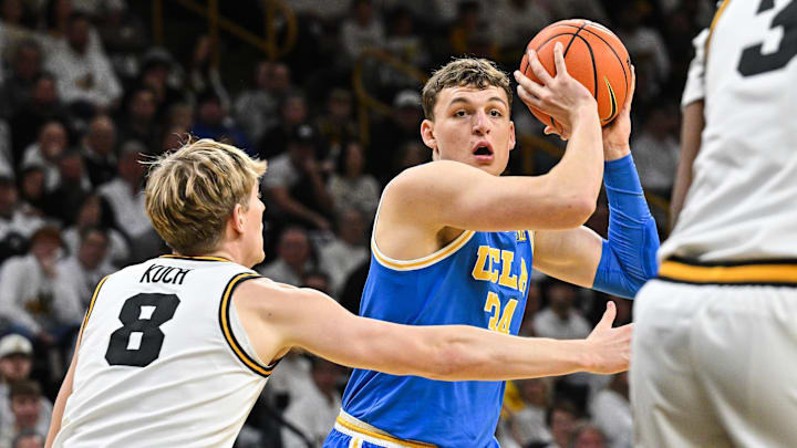Jan 3, 2026; Iowa City, Iowa, USA; UCLA Bruins forward Tyler Bilodeau (34) is defended by Iowa Hawkeyes forward Cooper Koch (8) during the first half at Carver-Hawkeye Arena. Mandatory Credit: Jeffrey Becker-Imagn Images