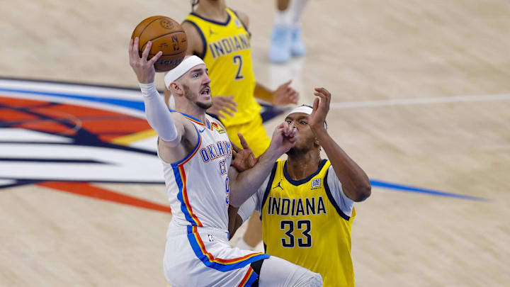 Jun 16, 2025; Oklahoma City, Oklahoma, USA; Oklahoma City Thunder guard Alex Caruso (9) drives to the basket past Indiana Pacers center Myles Turner (33) in the first quarter during game five of the 2025 NBA Finals at Paycom Center. Mandatory Credit: Alonzo Adams-Imagn Images