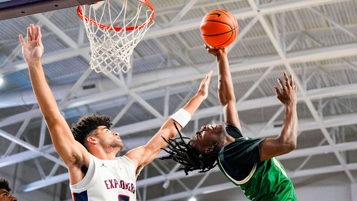 Grayson Rams guard Caleb Holt (3) makes an acrobatic lay up attempt while being guarded by Columbus Explorers guard Cayden Boozer (2) during the first quarter of a City of Palms Classic quarterfinal game at Suncoast Credit Union Arena in Fort Myers, Fla., on Friday, Dec. 20, 2024.