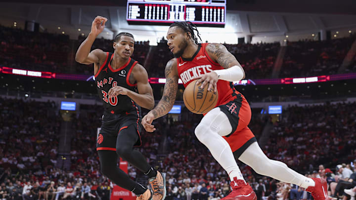 Feb 9, 2025; Houston, Texas, USA; Houston Rockets forward Cam Whitmore (7) drives with the ball as Toronto Raptors guard Ochai Agbaji (30) defends during the fourth quarter at Toyota Center. Mandatory Credit: Troy Taormina-Imagn Images