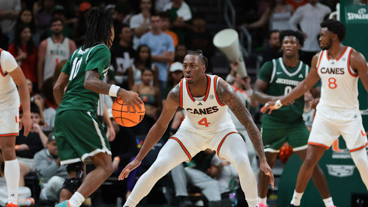 Nov 3, 2025; Coral Gables, Florida, USA; Miami Hurricanes guard Marcus Allen (4) defends against Jacksonville Dolphins guard Simon Wheeler (10) during the first half at Watsco Center. Mandatory Credit: Sam Navarro-Imagn Images
