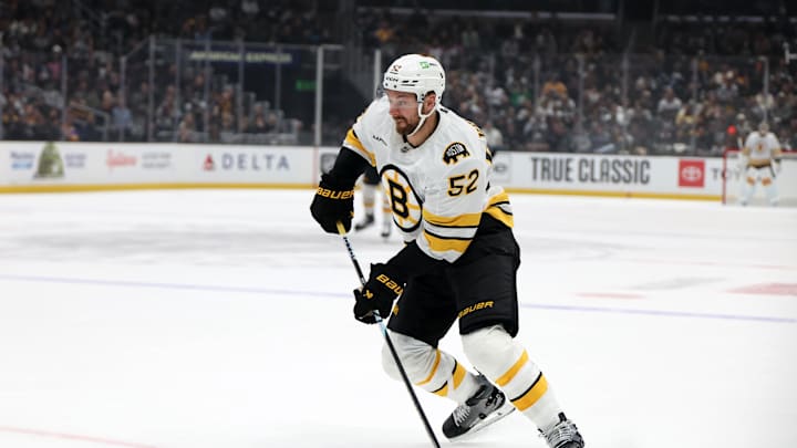 Nov 21, 2025; Los Angeles, California, USA;  Boston Bruins center Sean Kuraly (52) skates with the puck during the first period against the Los Angeles Kings at Crypto.com Arena. Mandatory Credit: Kiyoshi Mio-Imagn Images