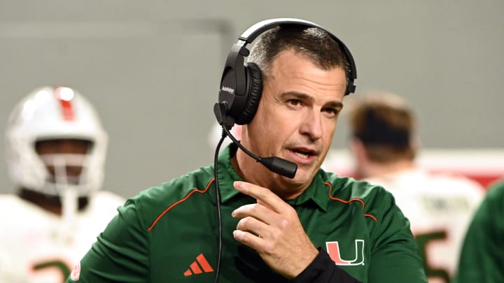 Nov 4, 2023; Raleigh, North Carolina, USA; Miami Hurricanes head coach Mario Cristobal looks on during the first half against the North Carolina State Wolfpack at Carter-Finley Stadium. Mandatory Credit: Rob Kinnan-USA TODAY Sports Nov 4, 2023; Raleigh, North Carolina, USA; Miami Hurricanes head coach Mario Cristobal looks on during the first half against the North Carolina State Wolfpack at Carter-Finley Stadium. Mandatory Credit: Rob Kinnan-USA TODAY Sports