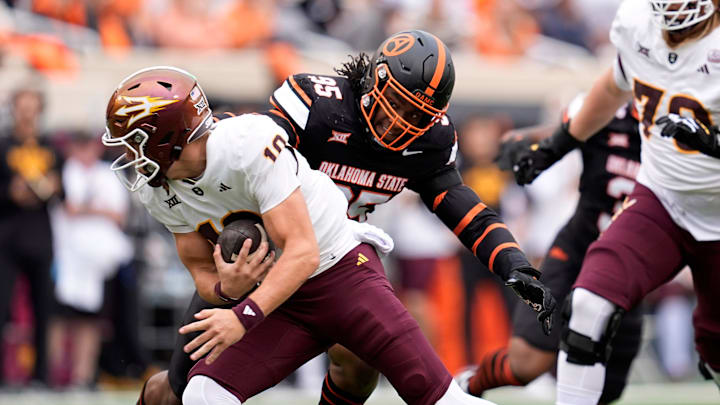 Oklahoma State Cowboys defensive end Jaleel Johnson (95) sacks Arizona State Sun Devils quarterback Sam Leavitt (10) during the college football game between the Oklahoma State Cowboys and the Arizona State Sun Devils at Boone Pickens Stadium in Stillwater, OK on Saturday, Nov. 2, 2024.