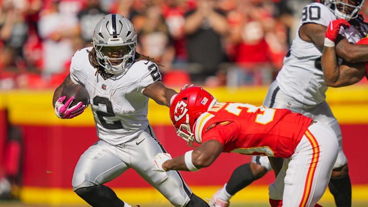 Oct 19, 2025; Kansas City, Missouri, USA; Las Vegas Raiders running back Ashton Jeanty (2) runs the ball against Kansas City Chiefs cornerback Chris Roland-Wallace (30) during the first half at GEHA Field at Arrowhead Stadium. Mandatory Credit: Jay Biggerstaff-Imagn Images