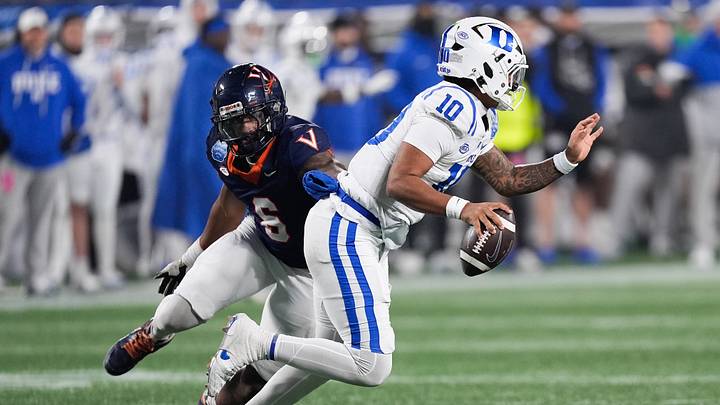 Dec 6, 2025; Charlotte, NC, USA; Virginia Cavaliers defensive end Cazeem Moore (6) pressures Duke Blue Devils quarterback Darian Mensah (10) in the second half during the 2025 ACC Championship game at Bank of America Stadium. Mandatory Credit: Jim Dedmon-Imagn Images Dec 6, 2025; Charlotte, NC, USA; Virginia Cavaliers defensive end Cazeem Moore (6) pressures Duke Blue Devils quarterback Darian Mensah (10) in the second half during the 2025 ACC Championship game at Bank of America Stadium. Mandatory Credit: Jim Dedmon-Imagn Images