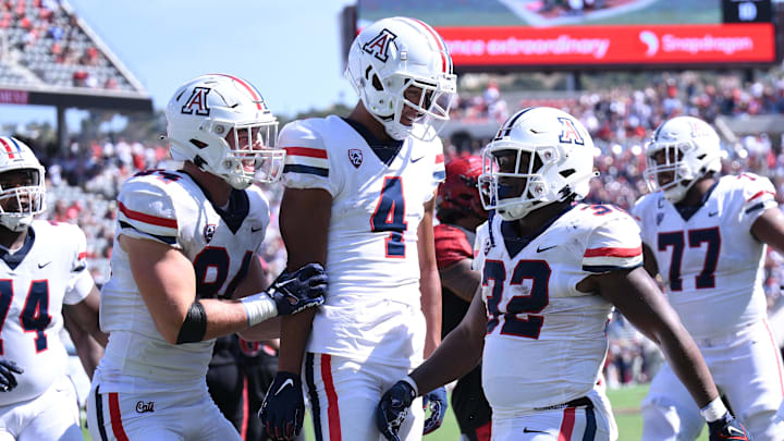 Sep 3, 2022; San Diego, California, USA; Arizona Wildcats running back DJ Williams (32) celebrates with tight end Tanner McLachlan (84) and wide receiver Tetairoa McMillan (4) after scoring a touchdown against the San Diego State Aztecs during the second half at Snapdragon Stadium. Mandatory Credit: Orlando Ramirez-Imagn Images