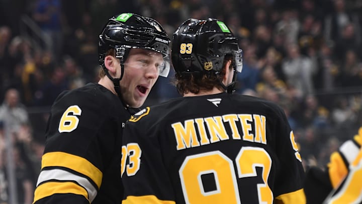 Apr 14, 2026; Boston, Massachusetts, USA; Boston Bruins defenseman Mason Lohrei (6) reacts with center Fraser Minten (93) after a goal by center Morgan Geekie (not pictured) during the first period against the New Jersey Devils at TD Garden. Mandatory Credit: Bob DeChiara-Imagn Images