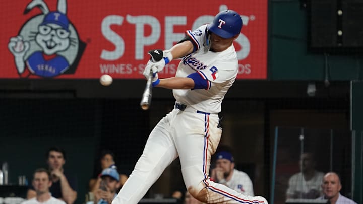 Apr 16, 2025; Arlington, Texas, USA; Texas Rangers shortstop Corey Seager (5) hits a two-run single during the second inning against the Los Angeles Angels at Globe Life Field. Mandatory Credit: Raymond Carlin III-Imagn Images