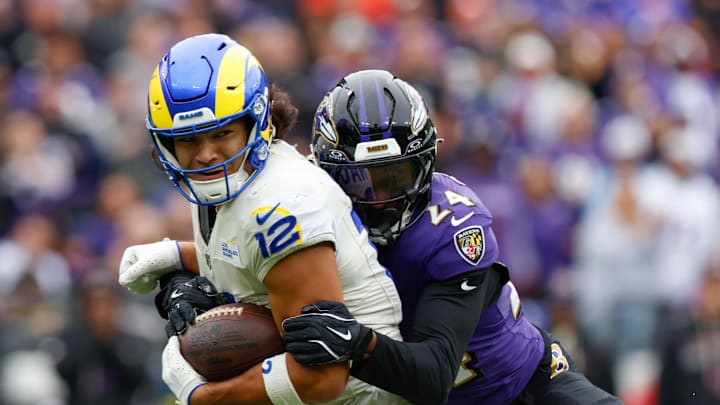 Oct 12, 2025; Baltimore, Maryland, USA; Baltimore Ravens safety Malaki Starks (24) tackles Los Angeles Rams wide receiver Puka Nacua (12) during the second quarter of the game at M&T Bank Stadium. Mandatory Credit: Peter Casey-Imagn Images
