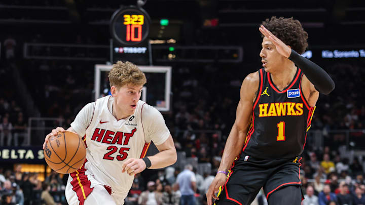 Dec 26, 2025; Atlanta, Georgia, USA; Miami Heat guard Kasparas Jakucionis (25) dribbles the ball towards the goal against Atlanta Hawks forward Jalen Johnson (1) during the first quarter at State Farm Arena. Mandatory Credit: Jordan Godfree-Imagn Images