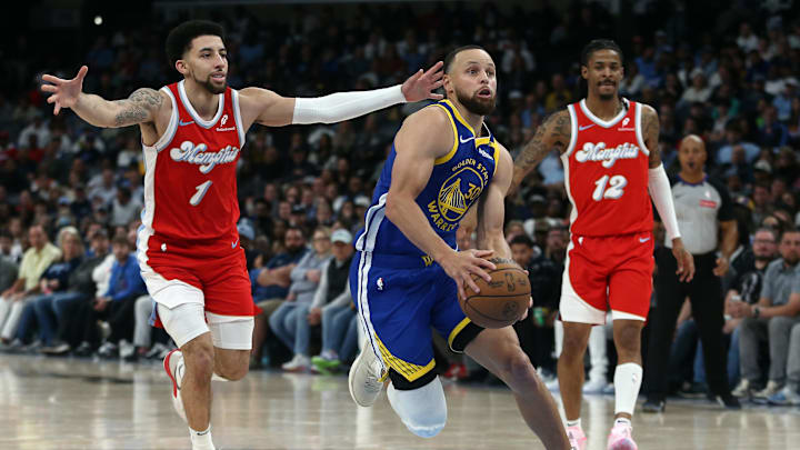 Apr 1, 2025; Memphis, Tennessee, USA; Golden State Warriors guard Stephen Curry (30) drives to the basket between Memphis Grizzlies guard Scotty Pippen Jr. (1) and guard Ja Morant (12) during the fourth quarter at FedExForum. Mandatory Credit: Petre Thomas-Imagn Images