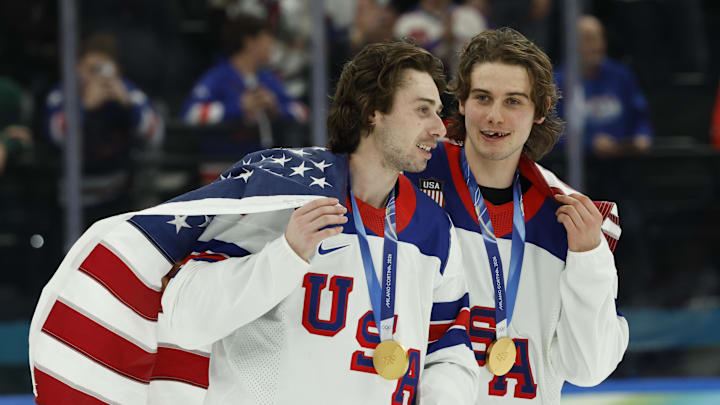 Feb 22, 2026; Milan, Italy; Quinn Hughes (43) of the United States and Jack Hughes (86) of the United States celebrate after defeating Canada in the men's ice hockey gold medal game during the Milano Cortina 2026 Olympic Winter Games at Milano Santagiulia Ice Hockey Arena. Mandatory Credit: Geoff Burke-Imagn Images
