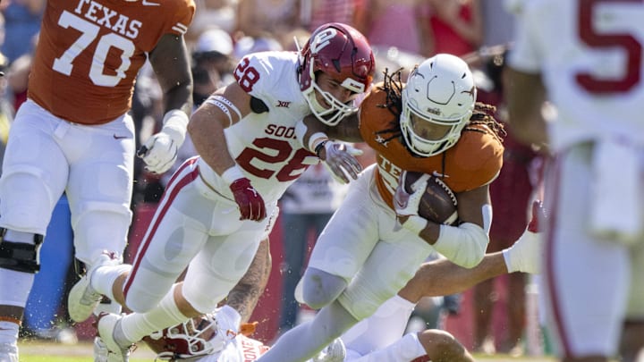 Oct 7, 2023; Dallas, Texas, USA; Texas Longhorns running back Jonathon Brooks (24) and Oklahoma Sooners linebacker Danny Stutsman (28) in action during the game between the Texas Longhorns and the Oklahoma Sooners at the Cotton Bowl. Mandatory Credit: Jerome Miron-Imagn Images