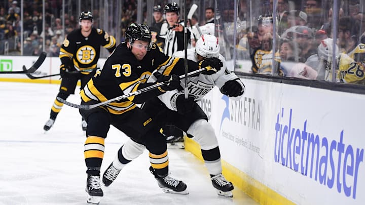 Mar 10, 2026; Boston, Massachusetts, USA;  Boston Bruins defenseman Charlie McAvoy (73) and Los Angeles Kings center Alex Turcotte (15) battle for the puck during the second period at TD Garden. Mandatory Credit: Bob DeChiara-Imagn Images
