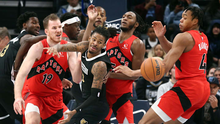 Jan 3, 2024; Memphis, Tennessee, USA; Memphis Grizzlies guard Ja Morant (12) looses control of the ball as Toronto Raptors center Jakob Poeltl (19), guard Immanuel Quickley (5) and forward Scottie Barnes (4) defends during the second half at FedExForum. Mandatory Credit: Petre Thomas-Imagn Images
