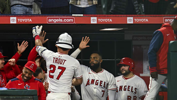 Apr 19, 2025; Anaheim, California, USA; Los Angeles Angels designated hitter Mike Trout (27) celebrates in the dugout after hitting a one run home run against the San Francisco Giants during the sixth inning at Angel Stadium. Mandatory Credit: Jonathan Hui-Imagn Images
