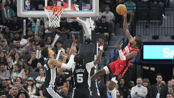 Oct 28, 2024; San Antonio, Texas, USA; Houston Rockets  guard Jalen Green (4) shoots over San Antonio Spurs guard Stephon Castle (5) and center Victor Wembanyama (1) during the second half at Frost Bank Center. Mandatory Credit: Scott Wachter-Imagn Images