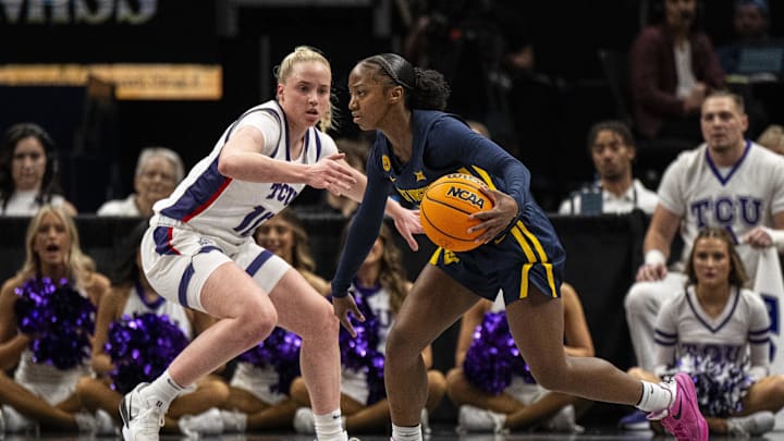 Mar 8, 2025; Kansas City, MO, USA; West Virginia Mountaineers guard Jordan Harrison (10) handles the ball while while defended by TCU Horned Frogs guard Hailey Van Lith (10) during the first half at T-Mobile Center. Mandatory Credit: Amy Kontras-Imagn Images