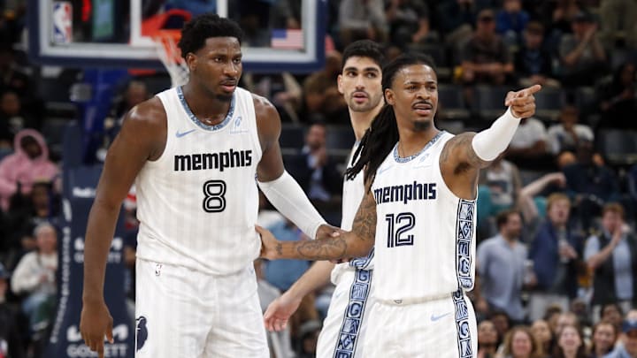 Dec 26, 2025; Memphis, Tennessee, USA; Memphis Grizzlies guard Ja Morant (12) reacts with forward/center Jaren Jackson Jr. (8) during the fourth quarter against the Milwaukee Bucks at FedExForum. Mandatory Credit: Petre Thomas-Imagn Images