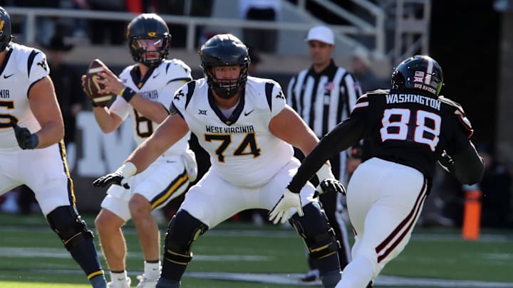 Nov 30, 2024; Lubbock, Texas, USA; West Virginia Mountaineers offensive lineman Wyatt Milum (74) prepares to block Texas Tech Red Raiders back Amier Washington (88) in the first half at Jones AT&T Stadium and Cody Campbell Field. Mandatory Credit: Michael C. Johnson-Imagn Images Nov 30, 2024; Lubbock, Texas, USA; West Virginia Mountaineers offensive lineman Wyatt Milum (74) prepares to block Texas Tech Red Raiders back Amier Washington (88) in the first half at Jones AT&T Stadium and Cody Campbell Field. Mandatory Credit: Michael C. Johnson-Imagn Images