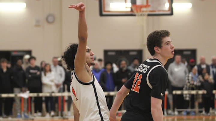 North's Ty Tabales hits a shot over Newton North's Teagan Swint during an MIAA Division I Final Four game.

Ty Tabales Teagan Swint