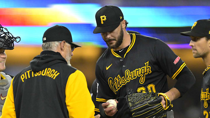 Pittsburgh Pirates right fielder Bryan Reynolds (10) pulls starting pitcher Paul Skenes (30) in the seventh inning against the Los Angeles Dodgers at Dodger Stadium on April 25.