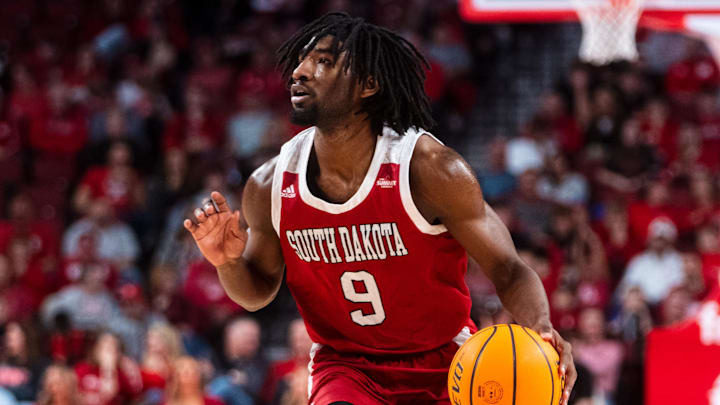 Nov 27, 2024; Lincoln, Nebraska, USA; South Dakota Coyotes guard Chase Forte (9) dribbles during the second half against the Nebraska Cornhuskers at Pinnacle Bank Arena. Mandatory Credit: Dylan Widger-Imagn Images