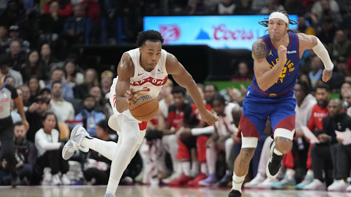 Oct 28, 2024; Toronto, Ontario, CAN; Toronto Raptors forward Scottie Barnes (4) drives to the net as Denver Nuggets forward Aaron Gordon (32) pursues during the second half at Scotiabank Arena. Mandatory Credit: John E. Sokolowski-Imagn Images