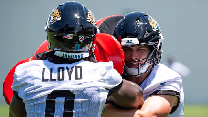 Jacksonville Jaguars linebacker Jack Kiser (54) makes a run at Jacksonville Jaguars linebacker Devin Lloyd (0) during a tackling drill during the fourth organized team activity at the Miller Electric Center in Jacksonville, Fla. Tuesday, May 27, 2025. [Doug Engle/Florida Times-Union]