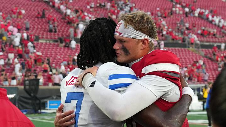 Sep 19, 2026; Louisville, Kentucky, USA; Southern Methodist Mustangs quarterback Kevin Jennings (7) hugs Louisville Cardinals quarterback Lincoln Kienholz (3) after the game at L&N Federal Credit Union Stadium. Mandatory Credit: Chris Carter-Imagn Images Sep 19, 2026; Louisville, Kentucky, USA; Southern Methodist Mustangs quarterback Kevin Jennings (7) hugs Louisville Cardinals quarterback Lincoln Kienholz (3) after the game at L&N Federal Credit Union Stadium. Mandatory Credit: Chris Carter-Imagn Images