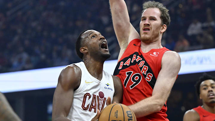 Nov 13, 2025; Cleveland, Ohio, USA; Cleveland Cavaliers center Evan Mobley (4) drives to the basket beside Toronto Raptors center Jakob Poeltl (19) in the first quarter at Rocket Arena. Mandatory Credit: David Richard-Imagn Images