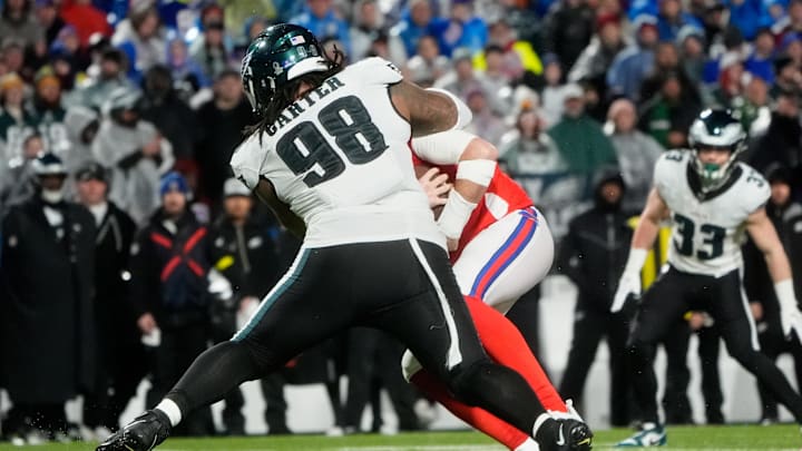 Dec 28, 2025; Orchard Park, New York, USA; Philadelphia Eagles defensive tackle Jalen Carter (98) sacks Buffalo Bills quarterback Josh Allen (17) during the second quarter at Highmark Stadium. 