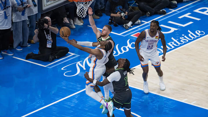 May 20, 2025; Oklahoma City, Oklahoma, USA; Oklahoma City Thunder forward Jalen Williams (8) shoots against Minnesota Timberwolves guard Donte DiVincenzo (0) and center Naz Reid (11) in the fourth quarter during game one of the western conference finals for the 2025 NBA Playoffs at Paycom Center. Mandatory Credit: Brett Rojo-Imagn Images May 20, 2025; Oklahoma City, Oklahoma, USA; Oklahoma City Thunder forward Jalen Williams (8) shoots against Minnesota Timberwolves guard Donte DiVincenzo (0) and center Naz Reid (11) in the fourth quarter during game one of the western conference finals for the 2025 NBA Playoffs at Paycom Center. Mandatory Credit: Brett Rojo-Imagn Images