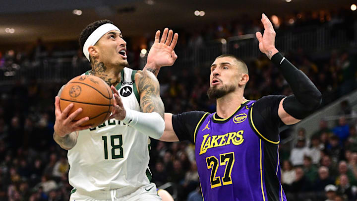Milwaukee Bucks forward Kyle Kuzma takes a shot against Los Angeles Lakers guard Luka Doncic in the first quarter at Fiserv Forum on Thursday.