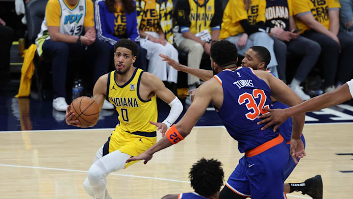 May 27, 2025; Indianapolis, Indiana, USA; Indiana Pacers guard Tyrese Haliburton (0) drives to the hoop past New York Knicks center Karl-Anthony Towns (32) during the fourth quarter of game four of the eastern conference finals for the 2025 NBA Playoffs at Gainbridge Fieldhouse. Mandatory Credit: Trevor Ruszkowski-Imagn Images May 27, 2025; Indianapolis, Indiana, USA; Indiana Pacers guard Tyrese Haliburton (0) drives to the hoop past New York Knicks center Karl-Anthony Towns (32) during the fourth quarter of game four of the eastern conference finals for the 2025 NBA Playoffs at Gainbridge Fieldhouse. Mandatory Credit: Trevor Ruszkowski-Imagn Images