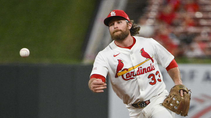 Aug 11, 2025; St. Louis, Missouri, USA;  St. Louis Cardinals second baseman Brendan Donovan (33) flips the ball to first base during the ninth inning against the Colorado Rockies at Busch Stadium. Mandatory Credit: Jeff Curry-Imagn Images