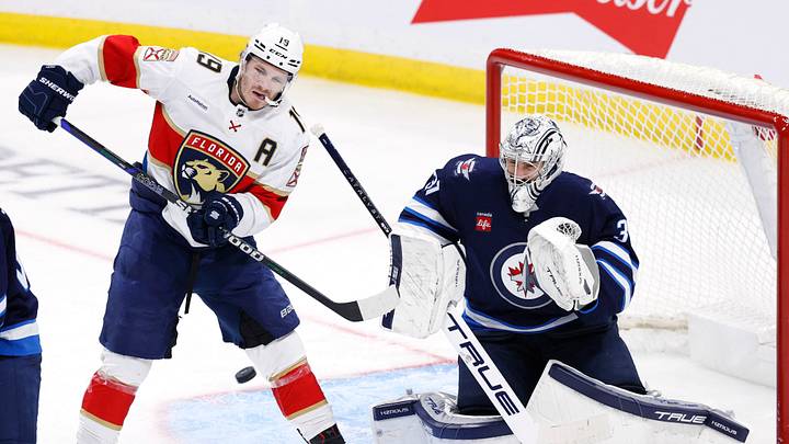 Nov 19, 2024; Winnipeg, Manitoba, CAN; Florida Panthers left wing Matthew Tkachuk (19) tries for a tip in on Winnipeg Jets goaltender Connor Hellebuyck (37) in the third period at Canada Life Centre. Mandatory Credit: James Carey Lauder-Imagn Images Nov 19, 2024; Winnipeg, Manitoba, CAN; Florida Panthers left wing Matthew Tkachuk (19) tries for a tip in on Winnipeg Jets goaltender Connor Hellebuyck (37) in the third period at Canada Life Centre. Mandatory Credit: James Carey Lauder-Imagn Images