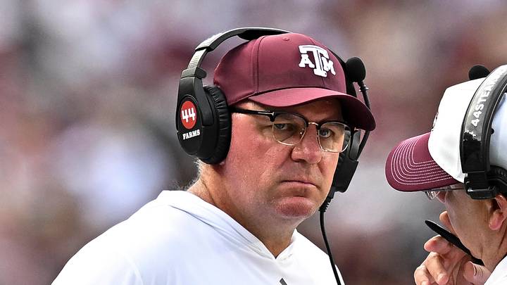 Texas A&M Aggies head coach Mike Elko speaks with a member of his coaching staff during a time-out in the fourth quarter against the Kentucky Wildcats at Kyle Field. Texas A&M Aggies head coach Mike Elko speaks with a member of his coaching staff during a time-out in the fourth quarter against the Kentucky Wildcats at Kyle Field.