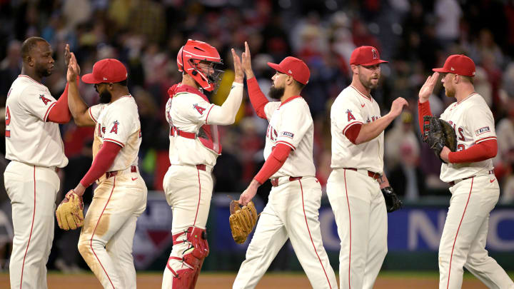 Apr 8, 2024; Anaheim, California, USA; Los Angeles Angels designated hitter Miguel Sano (22), third baseman Luis Rengifo (2), catcher Logan O'Hoppe (14), third baseman Anthony Rendon (6), pitcher Hunter Strickland (61), and second baseman Brandon Drury (23) leave the field after the final out of the ninth inning defeating the Tampa Bay Rays at Angel Stadium. 