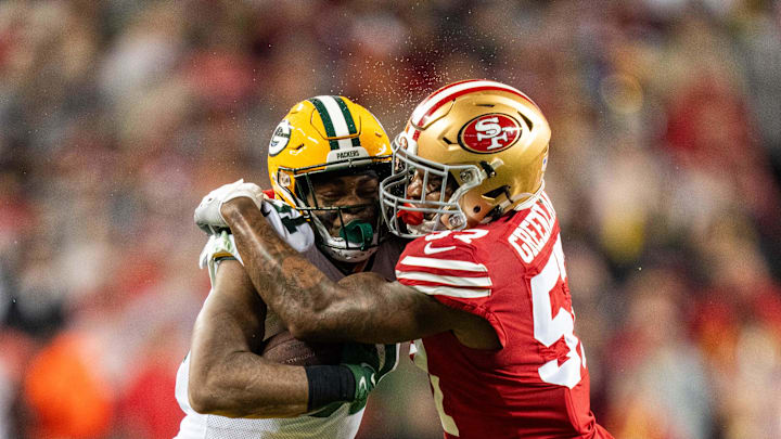 January 20, 2024; Santa Clara, CA, USA; San Francisco 49ers linebacker Dre Greenlaw (57) tackles Green Bay Packers running back Emanuel Wilson (31) during the first quarter in a 2024 NFC divisional round game at Levi's Stadium. Mandatory Credit: Kyle Terada-Imagn Images