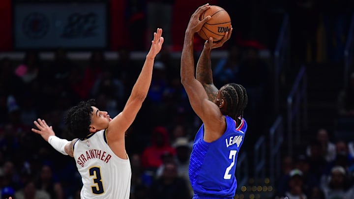Nov 27, 2023; Los Angeles, California, USA; Los Angeles Clippers forward Kawhi Leonard (2) shoots against Denver Nuggets guard Julian Strawther (3) during the second half at Crypto.com Arena. 