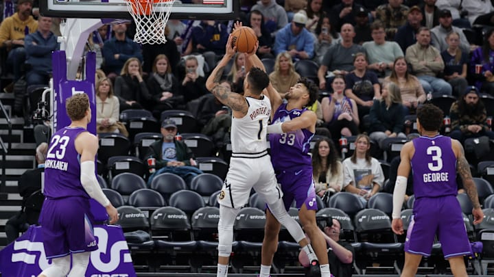 Dec 30, 2024; Salt Lake City, Utah, USA; Utah Jazz guard Johnny Juzang (33) tries to block the shot of Denver Nuggets forward Michael Porter Jr. (1) during the second half at Delta Center. Mandatory Credit: Chris Nicoll-Imagn Images