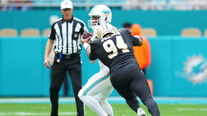Nov 30, 2025; Miami Gardens, Florida, USA; New Orleans Saints defensive end Cameron Jordan (94) applies pressure on Miami Dolphins quarterback Tua Tagovailoa (1) during the first half at Hard Rock Stadium. Mandatory Credit: Rich Storry-Imagn Images Nov 30, 2025; Miami Gardens, Florida, USA; New Orleans Saints defensive end Cameron Jordan (94) applies pressure on Miami Dolphins quarterback Tua Tagovailoa (1) during the first half at Hard Rock Stadium. Mandatory Credit: Rich Storry-Imagn Images