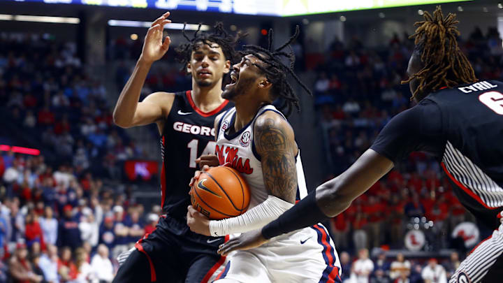 Jan 4, 2025; Oxford, Mississippi, USA; Mississippi Rebels guard Dre Davis (14) drives to the basket between Georgia Bulldogs forward Asa Newell (14) and center Somtochukwu Cyril (6) during the second half at The Sandy and John Black Pavilion at Ole Miss. Mandatory Credit: Petre Thomas-Imagn Images