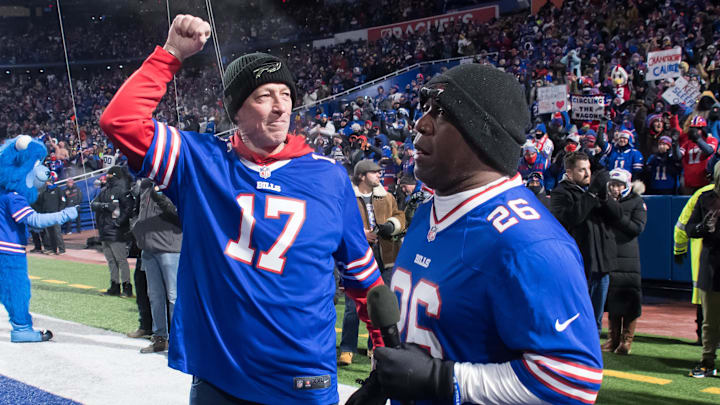Jan 15, 2022; Orchard Park, New York, USA; NFL Hall of Fame members and former Buffalo Bills players Jim Kelly (left) and Thurman Thomas prepare to get the crowd fired up before an AFC Wild Card playoff football game against the New England Patriots