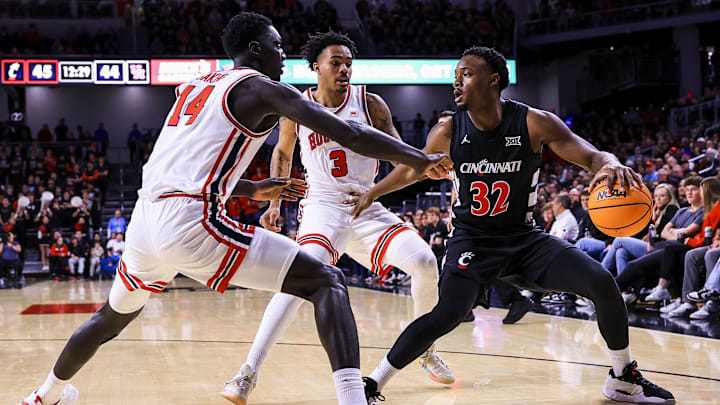 Jan 3, 2026; Cincinnati, Ohio, USA; Cincinnati Bearcats forward Jalen Celestine (32) dribbles against Houston Cougars forward Kalifa Sakho (14) and guard Ramon Walker Jr. (3) in the second half at Fifth Third Arena. Mandatory Credit: Katie Stratman-Imagn Images Jan 3, 2026; Cincinnati, Ohio, USA; Cincinnati Bearcats forward Jalen Celestine (32) dribbles against Houston Cougars forward Kalifa Sakho (14) and guard Ramon Walker Jr. (3) in the second half at Fifth Third Arena. Mandatory Credit: Katie Stratman-Imagn Images