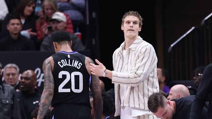 Feb 28, 2025; Salt Lake City, Utah, USA; Utah Jazz forward Lauri Markkanen (right) reacts to forward John Collins heading to the bench during the second half at Delta Center. Mandatory Credit: Rob Gray-Imagn Images
